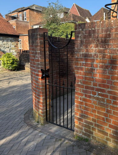 rear entrance gate refreshed with new coat of black paint